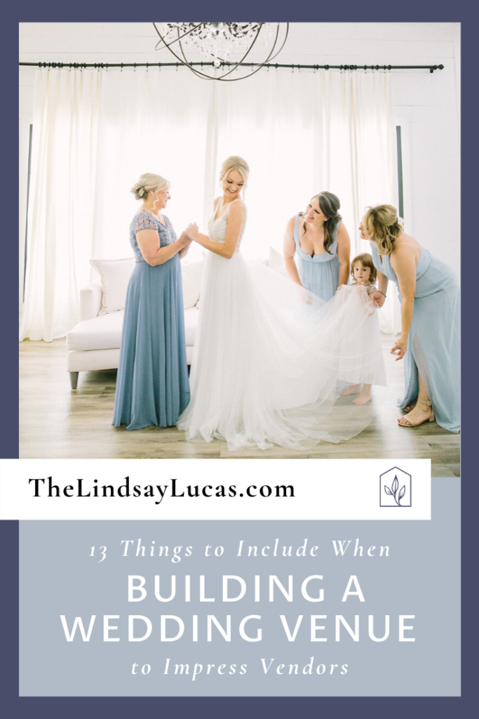 Bridesmaids surround a bride as they fluff her white wedding dress in the bridal suite.  Text overlays the image reading, 13 Things to Include When Building a Wedding Venue That Vendors Will Thank You For