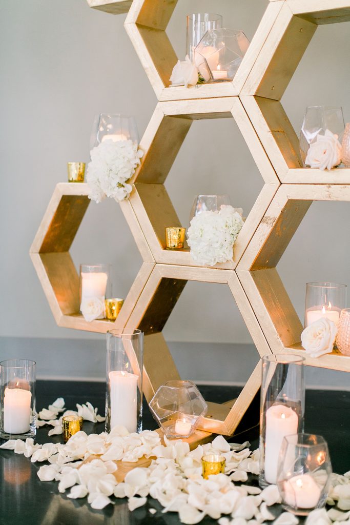 A golden honeycomb like archway decorated for a romantic wedding ceremony